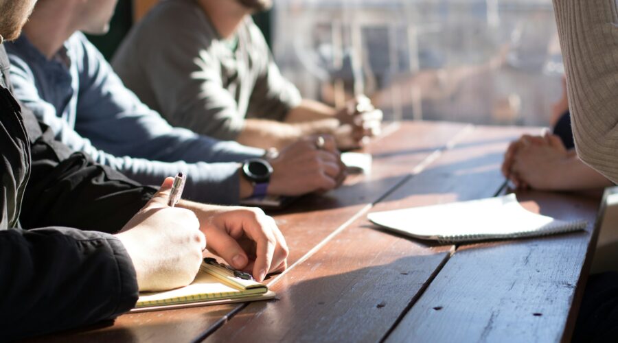 people at a table taking notes